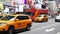 Yellow taxis and touristic bus in Times Square New York City