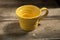 Yellow Teacup on a Wooden Surface
