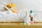 Yellow teddy bear with thermometer and plaster on head in white bedroom. Focus on medicament on a table