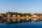 Yellow temples and buildings reflected in yamuna river at ghat in delhi