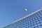 Yellow Tennis Ball Flying Over the Net