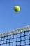 Yellow Tennis Ball Flying Over the Net