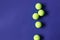 Yellow tennis balls on violet background. Concept sport.