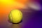 Yellow Tennis Sport Ball over Purple Background