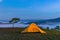 Yellow tent camping on hill under misty weather at dawn