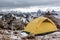 Yellow tent on mountain landscape