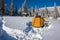 Yellow tent and snowshoes in a deep snow