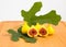 Yellow tiger figs with leaves on wooden cutting board. Selective focus