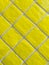 Yellow tiled wall pattern with textured glazed surface