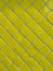 Yellow tiled wall pattern with textured glazed surface