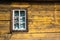 Yellow timbered wooden wall with white window