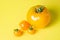 Yellow tomatoes on a yellow background. Ripe juicy tomatoes. Tomato variety.