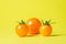 Yellow tomatoes on a yellow background. Ripe juicy tomatoes. Tomato variety.