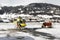 A yellow tour helicopter getting fuel in heliport in the alps switzerland in winter