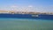 Yellow tourist boat Royal Seascope sails in El-Maya Bay of the Red Sea against the background of the Old City in Sharm El Sheikh