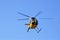 Yellow tourist helicopter in midair