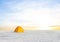 Yellow touristic tent among snowbound plain