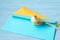 Yellow toy bird and colored envelopes for letters on blue background. Easy abstraction for background