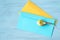 Yellow toy bird and colored envelopes for letters on blue background. Easy abstraction for background