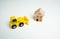 Yellow toy bulldozer and a house. Encroachment on private property. Illegal buildings and construction. Violation of building