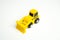 Yellow toy bulldozer, top view copy space. Demolition services, land leveling and other land works. Take down Illegal buildings.
