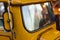 Yellow toy car with windshield reflection