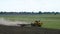 Yellow tractor cultivating in autumn.