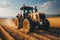 Yellow Tractor harvests in the field in summer, ground view