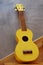 Yellow traditional soprano ukulele guitar
