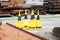 Yellow traffic cones at scrap metal industrial yard