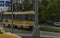 Yellow tram in Pilsen city on wet rainy street