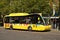 Yellow Transport for Greater Manchester bus waiting at a bus stop for passengers