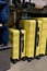 Yellow travel plastic suitcases with wheels in different sizes f