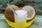 Yellow tray with coconuts and a glass of coconut water