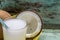 Yellow tray with coconuts and a glass of coconut water