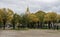 Yellow trees in the park in front of Les Invalides complex and Army museum with a cathedralâ€™s Dome on the background, Paris