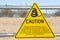 A yellow triangle sign with Snake caution warning