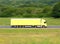 Yellow truck driving on a road