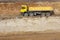 Yellow truck and going through gravel ground