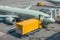 Yellow truck next to a passenger plane, pre-flight service airport