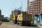 Yellow trucks stand on the roads near the construction site