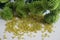 Yellow tubular toho beads and green Chrysanthemum on light cream background
