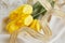 Yellow tulips, perfume and gold ribbon