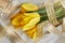 Yellow tulips, perfume and gold ribbon