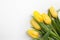 Yellow tulips on white wood background. Spring - poster with free text space.