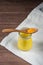 Yellow turmeric spice on a wooden spoon on a jar of golden milk. A healthy drink to strengthen immunity and fight viruses