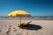 Yellow umbrella and beach background with empty yellow sunbeds.