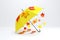 Yellow umbrella and multicolored maple leaves on white background