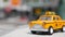 Yellow vacant mini taxi cab close up, Harmon corner, Las Vegas, USA. Small retro car model on defocused background