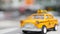 Yellow vacant mini taxi cab close up, Harmon corner, Las Vegas, USA. Small retro car model on defocused background. Little iconic